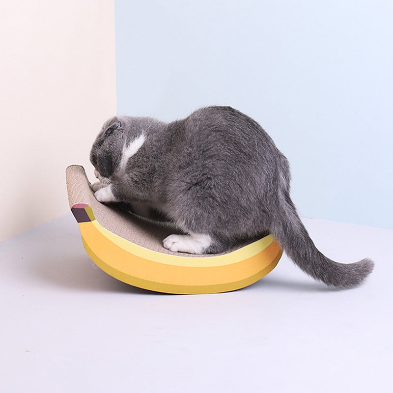 A playful cat engaging with the Banana Shaped Cat Scratching Pad.