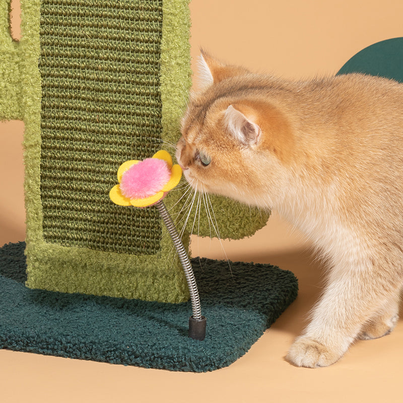 A cat playing with the flower-shaped toy on top of the Cactus Cat Scratcher.