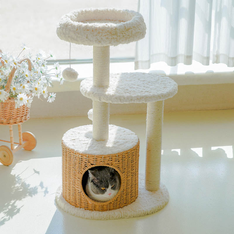 A cat inside the rattan-woven condo of the Milk Cloud Cat Tree