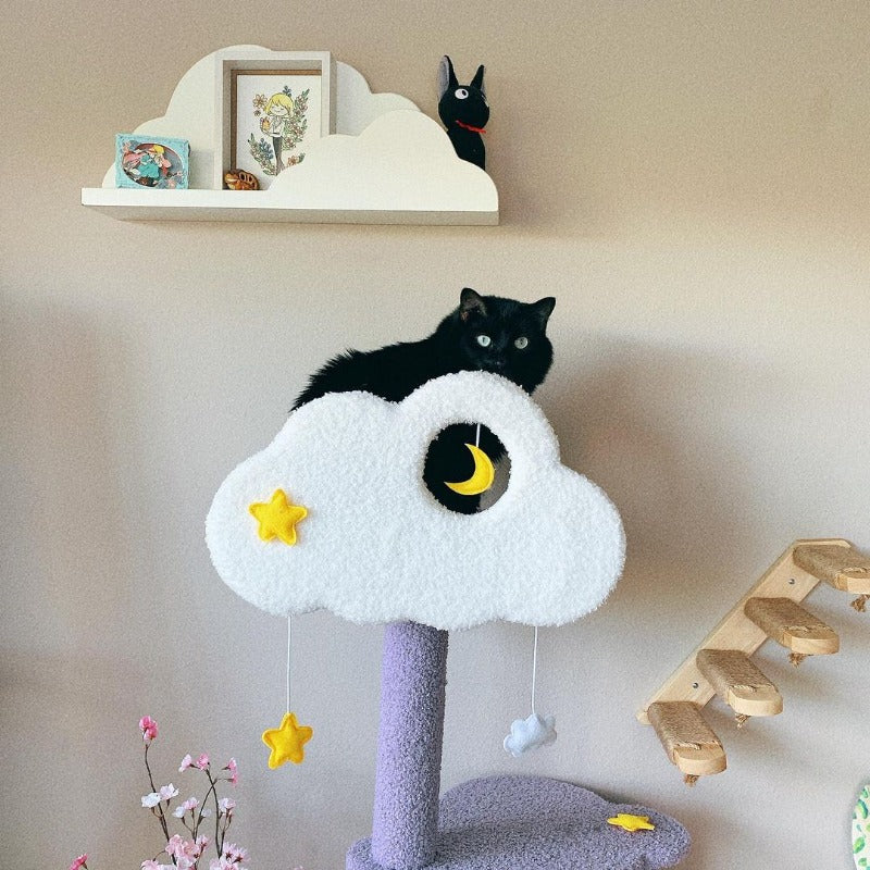 A black cat sitting on the top platform of the Moonlight Cat Tree