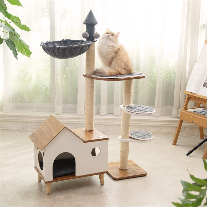 Cat sitting on top of the Wooden House Cat Tree – providing a high vantage point for your feline.